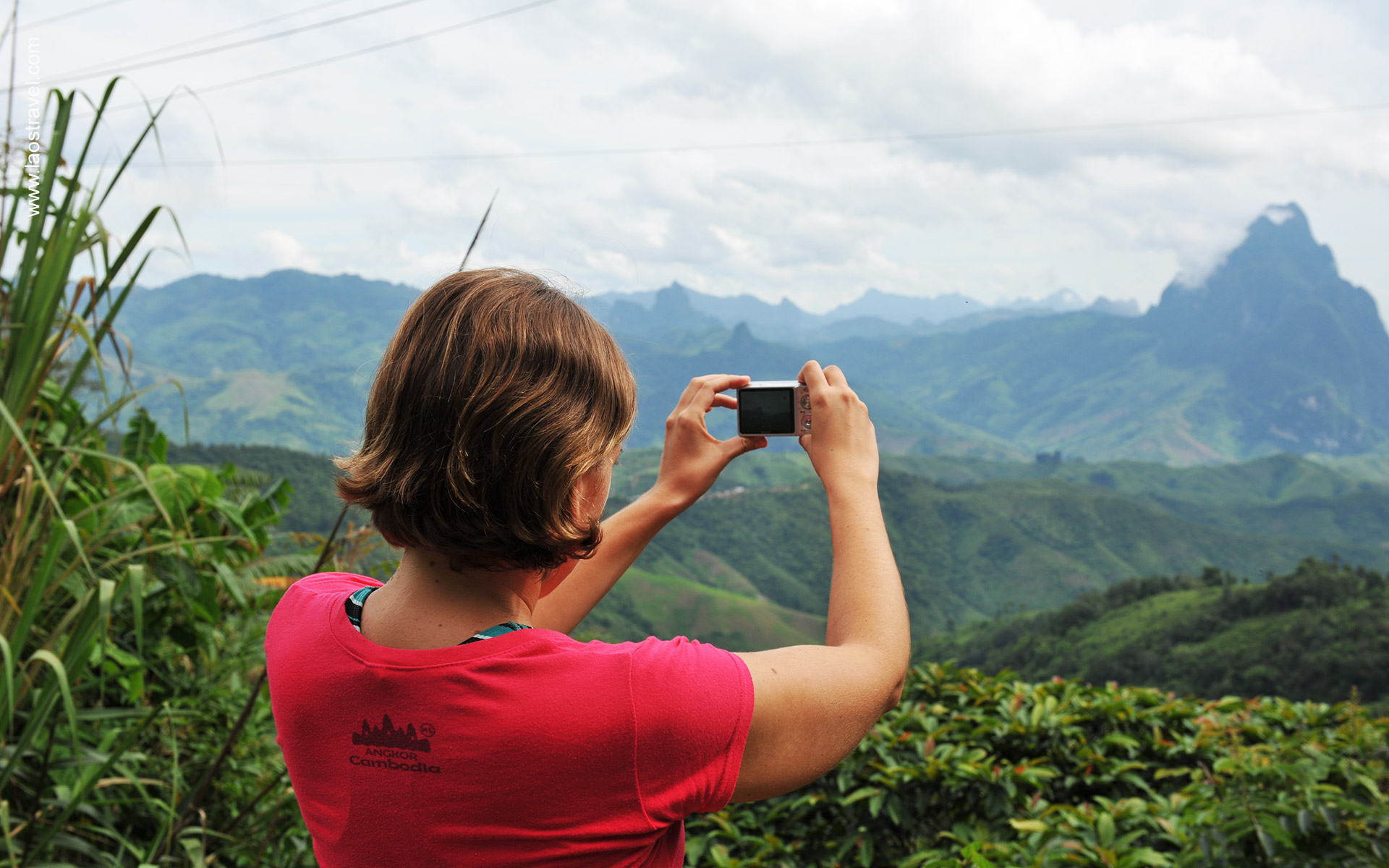 Aerial view of lush green forest and mountains in Laos, an enchanting travel destination